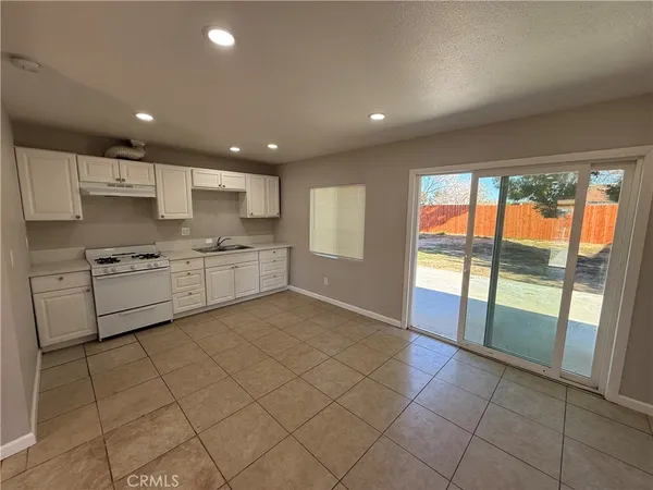a kitchen with a stove a sink and a refrigerator