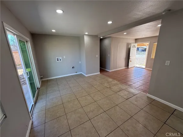a view of an empty room and a window