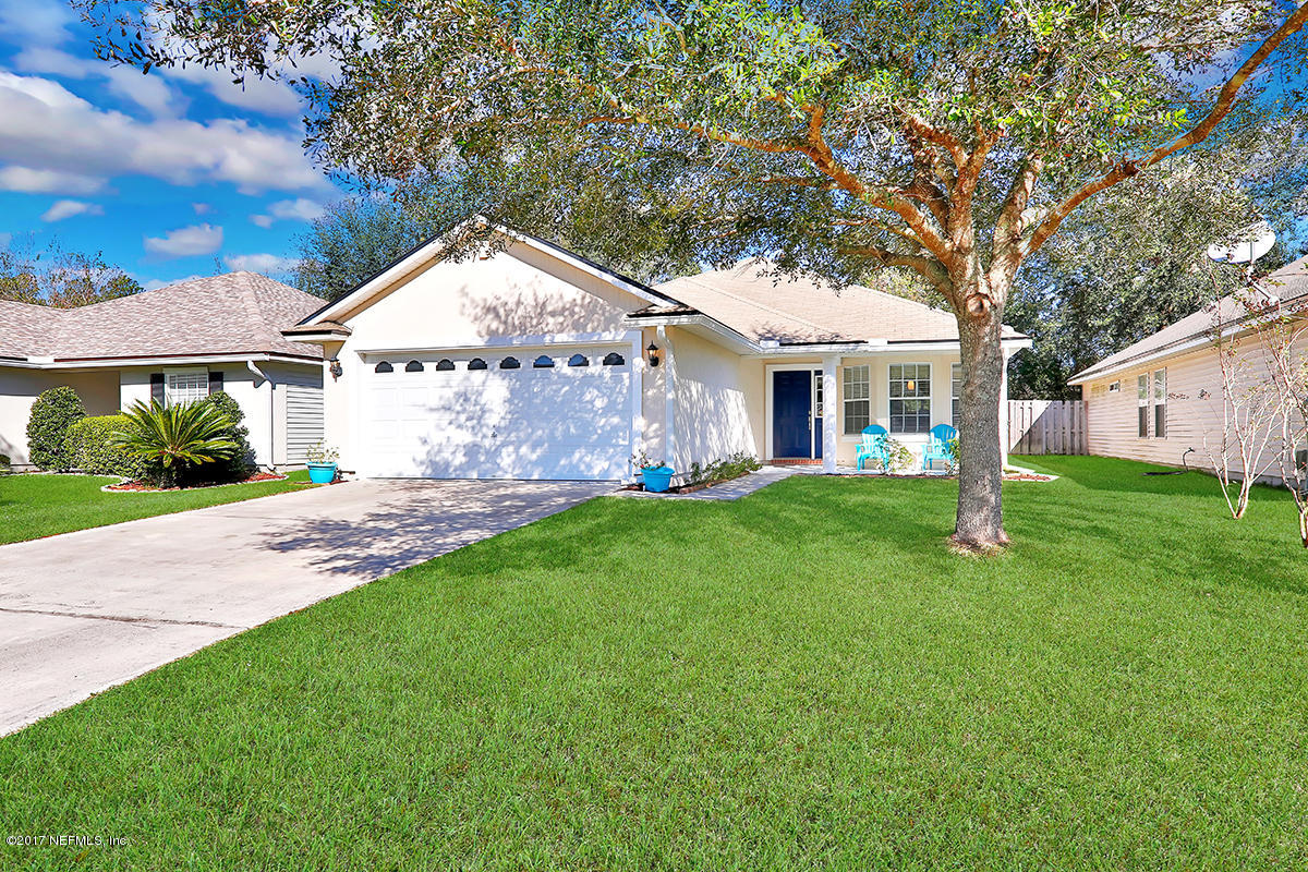 a front view of house with yard and green space