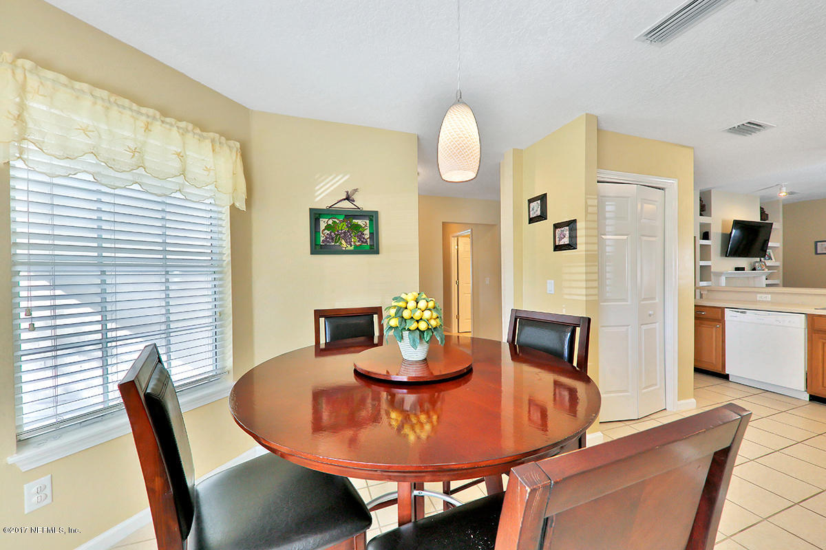 757 MacKenzie Circle St. Augustine, FL 32092 - Photo 11 of 31 a view of a dining room with furniture and wooden floor