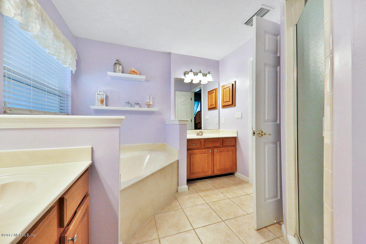 757 MacKenzie Circle St. Augustine, FL 32092 - Photo 18 of 31 a spacious bathroom with a tub sink and mirror