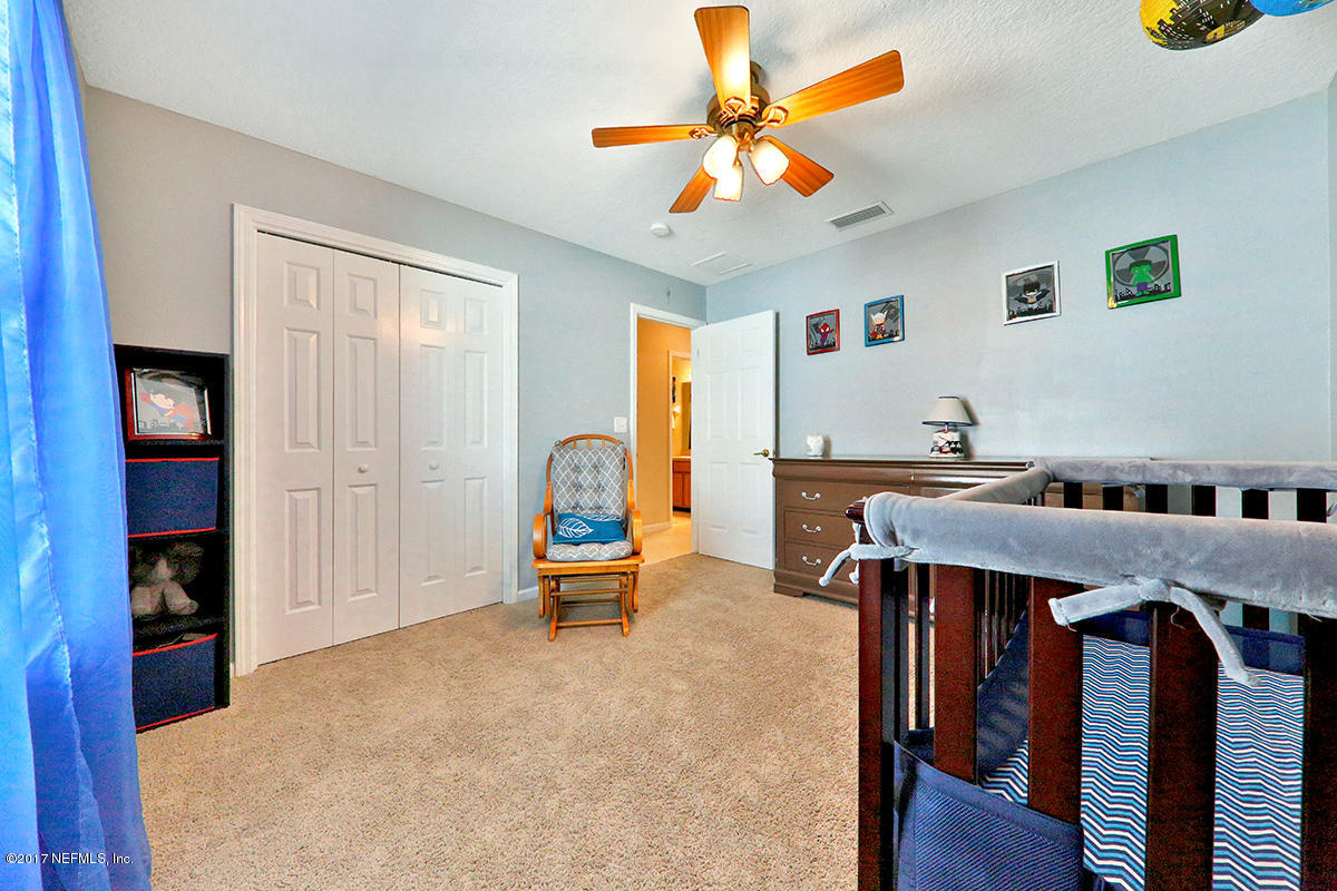 757 MacKenzie Circle St. Augustine, FL 32092 - Photo 20 of 31 a living room with furniture and a chandelier