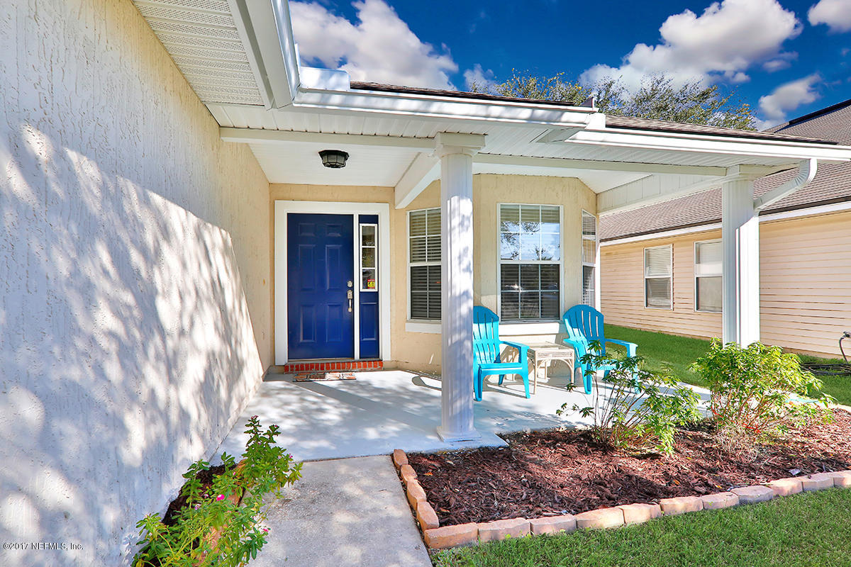 757 MacKenzie Circle St. Augustine, FL 32092 - Photo 2 of 31 a front view of a house with garden