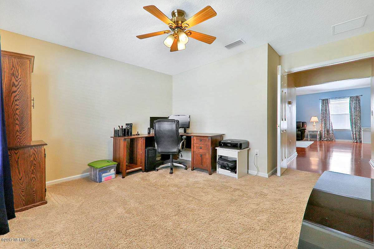 757 MacKenzie Circle St. Augustine, FL 32092 - Photo 21 of 31 a view of a workspace with furniture and a kitchen