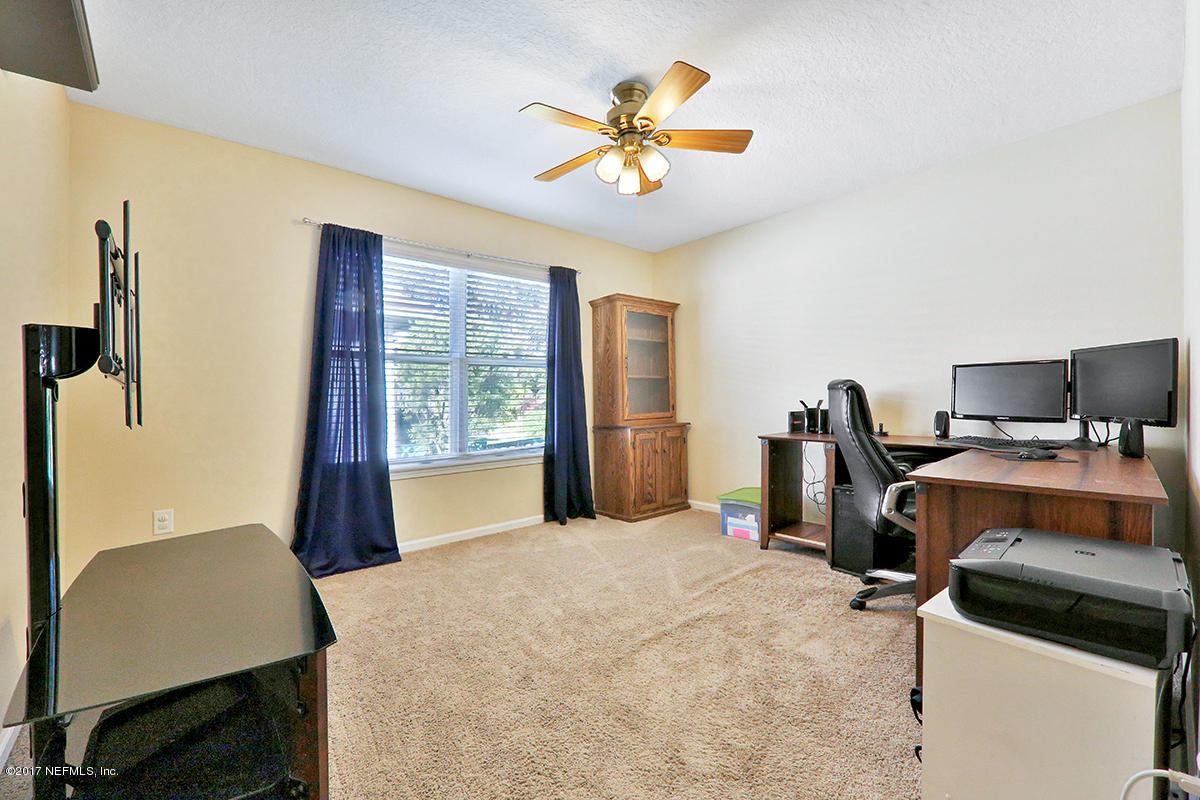 757 MacKenzie Circle St. Augustine, FL 32092 - Photo 22 of 31 a bedroom with a bed and a desk