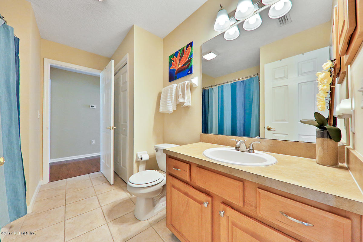 757 MacKenzie Circle St. Augustine, FL 32092 - Photo 23 of 31 a bathroom with a sink a toilet and a large mirror