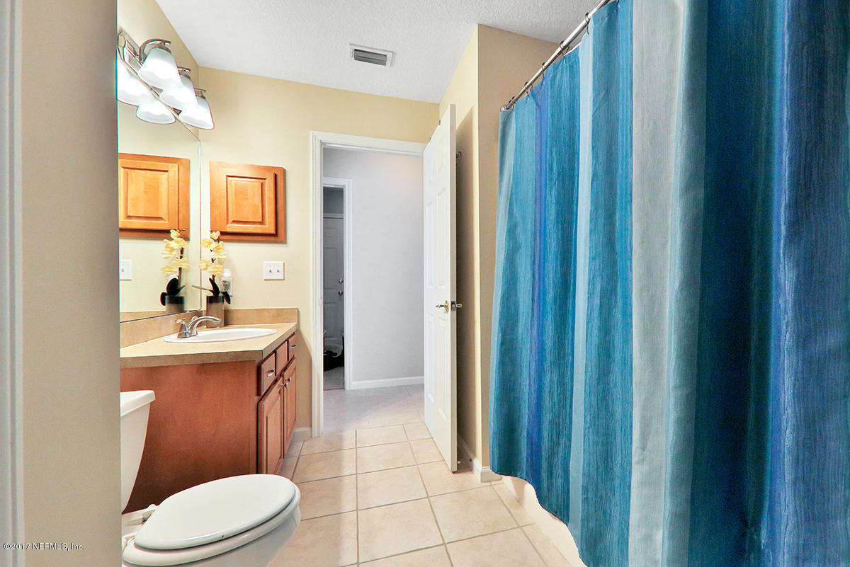 757 MacKenzie Circle St. Augustine, FL 32092 - Photo 24 of 31 a bathroom with a sink a toilet and shower a mirror