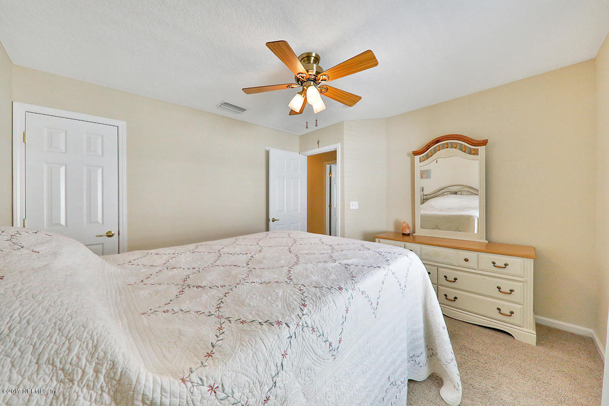 757 MacKenzie Circle St. Augustine, FL 32092 - Photo 26 of 31 a bedroom with a bed dresser and a window