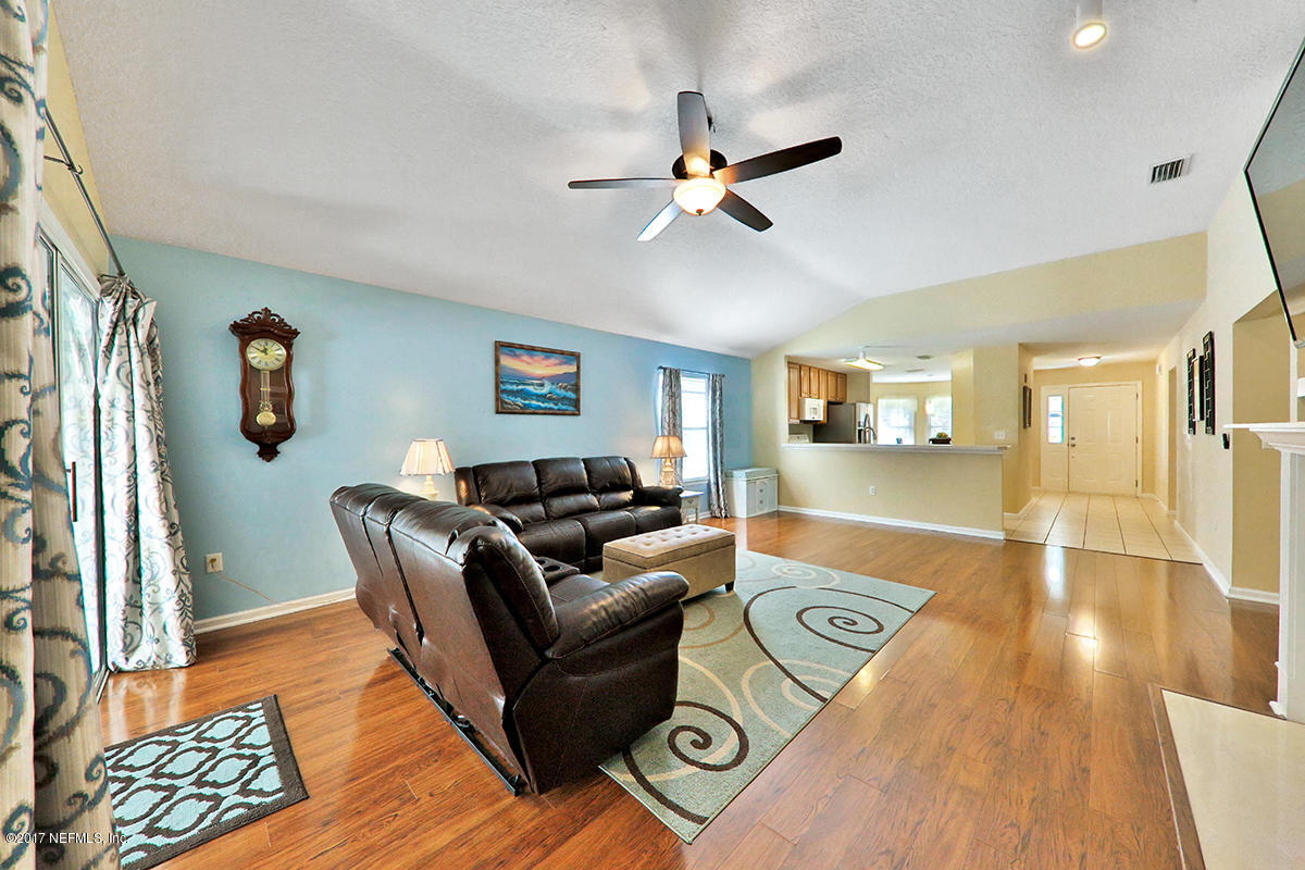 757 MacKenzie Circle St. Augustine, FL 32092 - Photo 3 of 31 a living room with furniture and a wooden floor