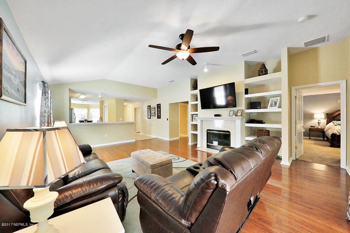 757 MacKenzie Circle St. Augustine, FL 32092 - Photo 5 of 31 a living room with furniture fireplace and flat screen tv