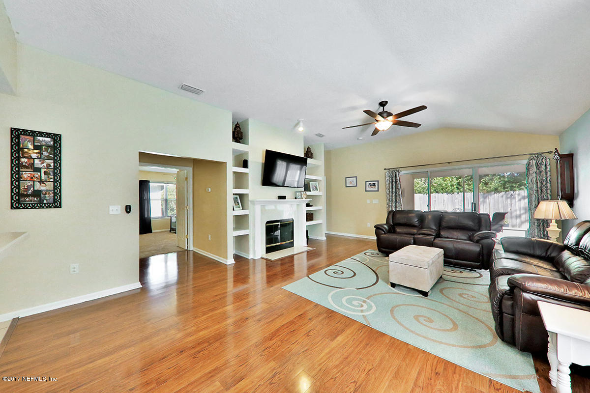 757 MacKenzie Circle St. Augustine, FL 32092 - Photo 6 of 31 a living room with fireplace furniture and a wooden floor