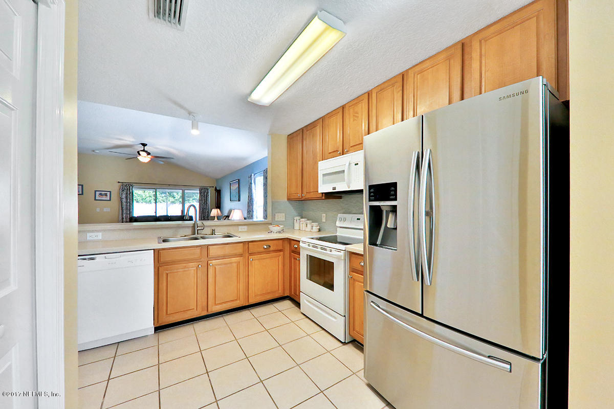 757 MacKenzie Circle St. Augustine, FL 32092 - Photo 7 of 31 a kitchen with stainless steel appliances a refrigerator sink and microwave