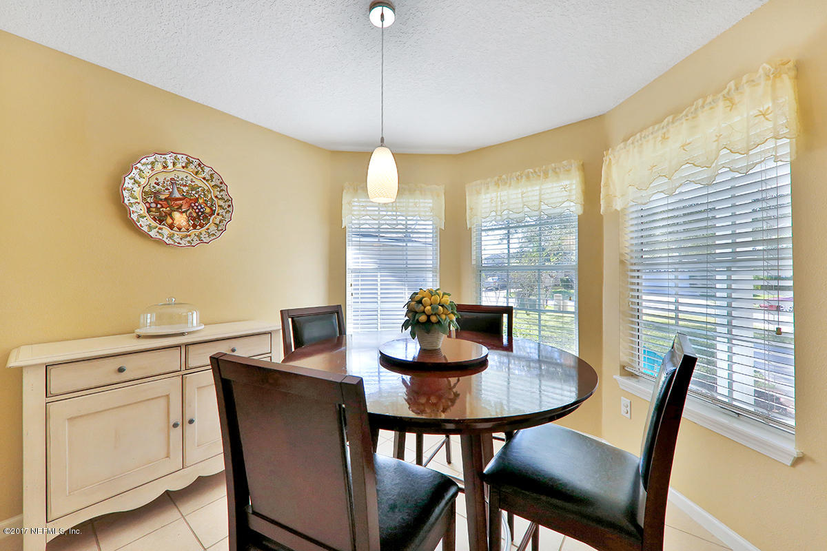 757 MacKenzie Circle St. Augustine, FL 32092 - Photo 9 of 31 a view of a dining room with furniture window and wooden floor