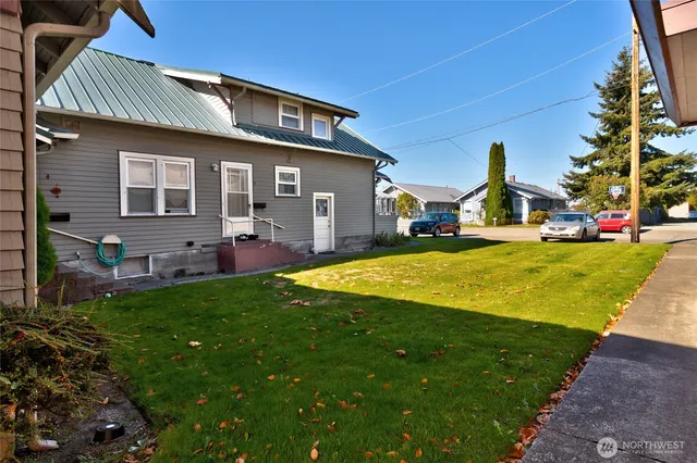 a front view of house with yard and outdoor seating