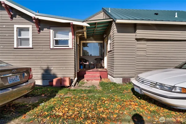 a backyard of a house with oven and chairs