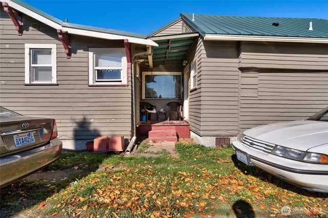 a backyard of a house with oven and chairs