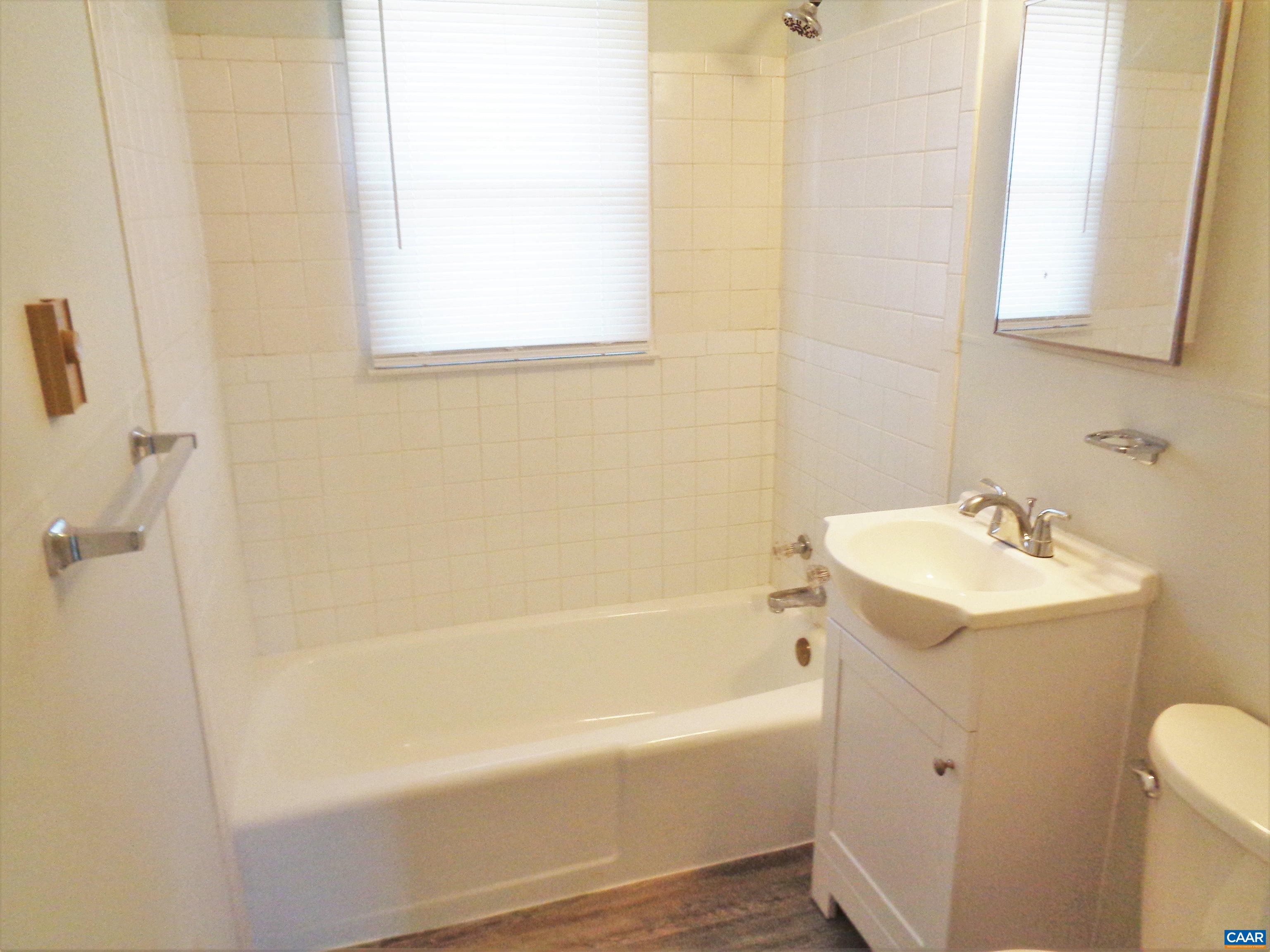 121 Abe Road Ruckersville, VA 22968 - Photo 17 of 28 a white bath tub sitting next to a white sink and vanity