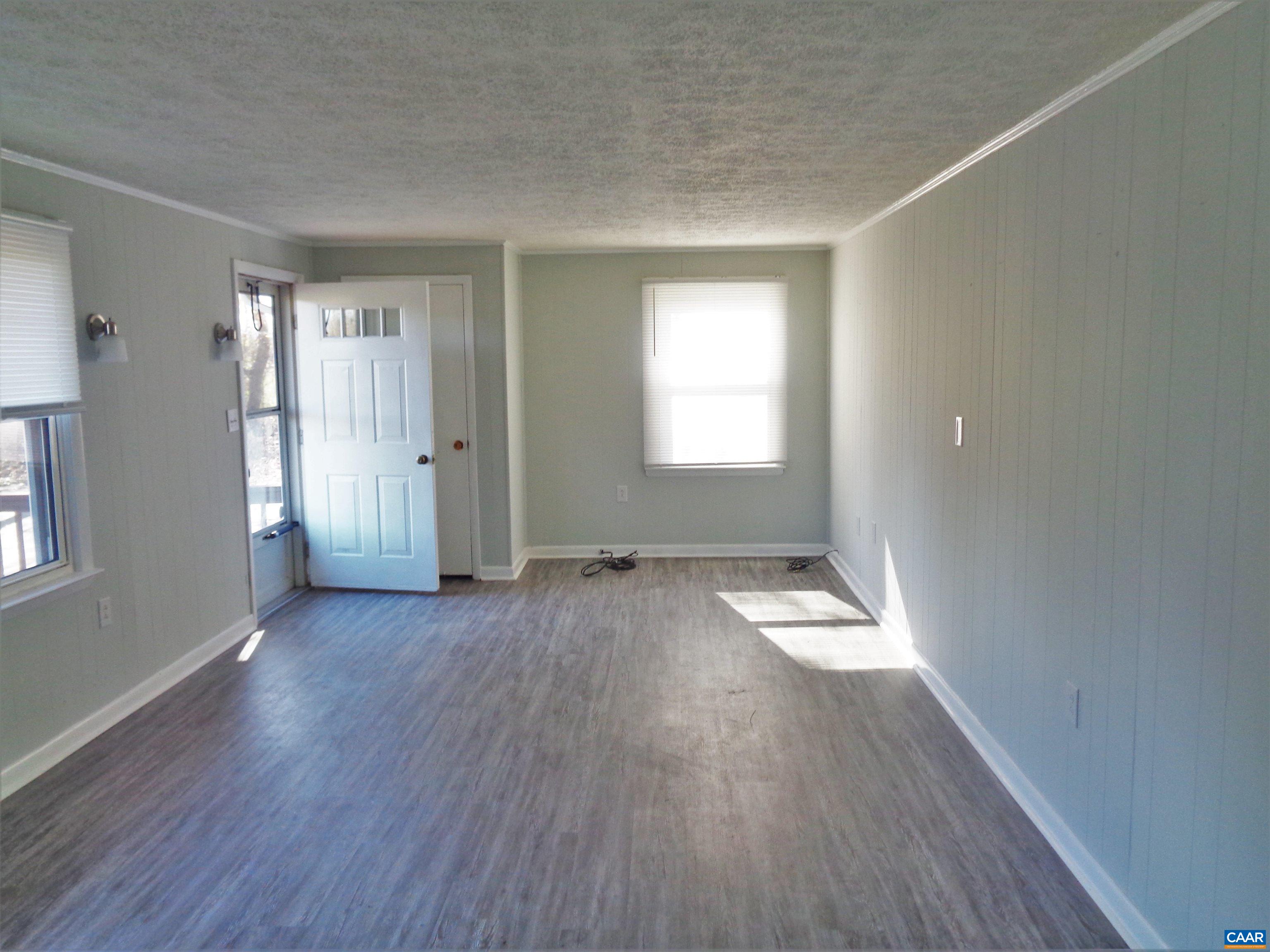 121 Abe Road Ruckersville, VA 22968 - Photo 9 of 28 an empty room with wooden floor and windows