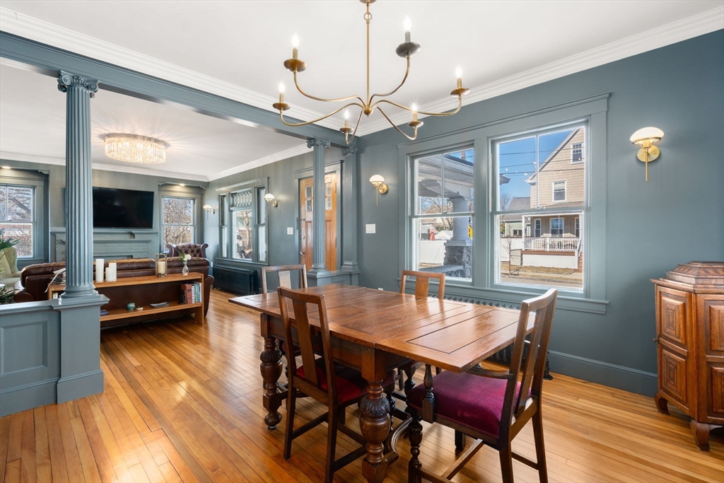 271 Atlantic Street Quincy, MA 02171 - Photo 16 of 24 a view of a dining room with furniture a chandelier and wooden floor