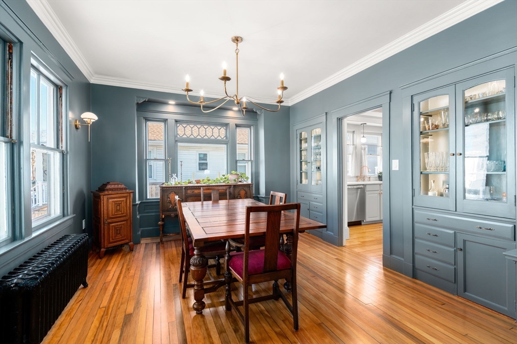 271 Atlantic Street Quincy, MA 02171 - Photo 17 of 24 a dining room with furniture a chandelier and wooden floor