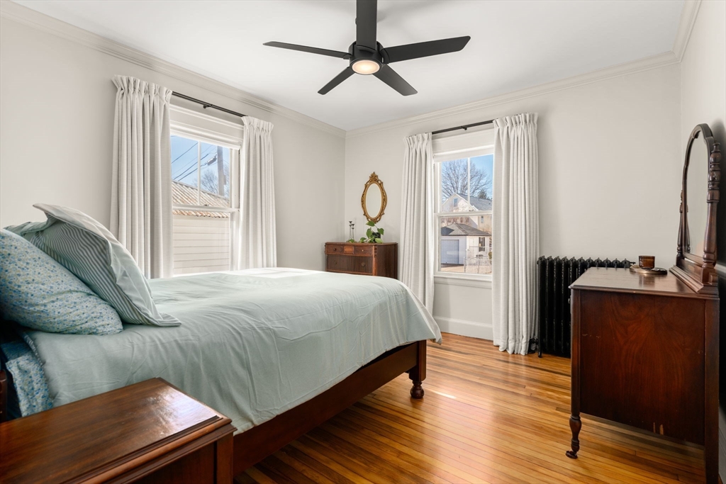 271 Atlantic Street Quincy, MA 02171 - Photo 20 of 24 a bedroom with a bed and wooden floor
