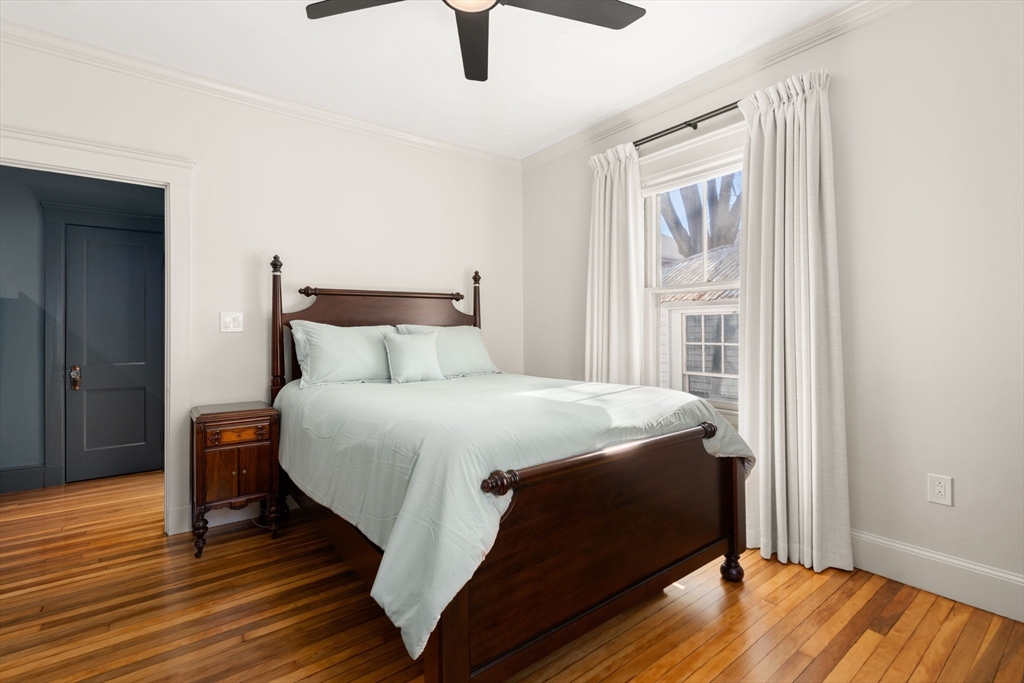 271 Atlantic Street Quincy, MA 02171 - Photo 21 of 24 a bedroom with a bed and wooden floor