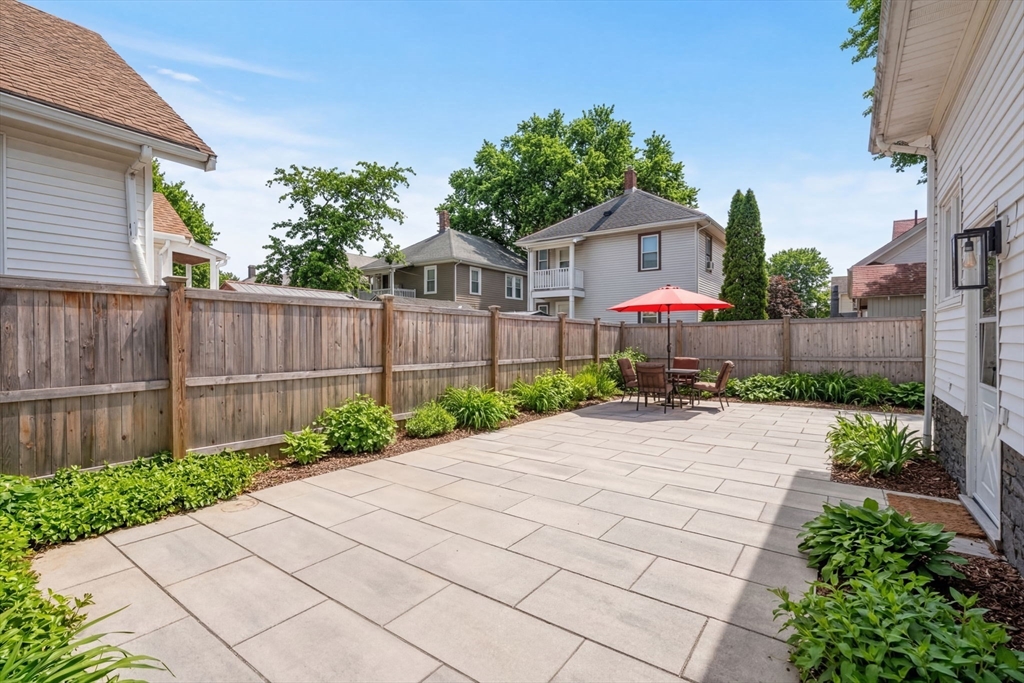 271 Atlantic Street Quincy, MA 02171 - Photo 3 of 24 a front view of a house with a yard and a garage