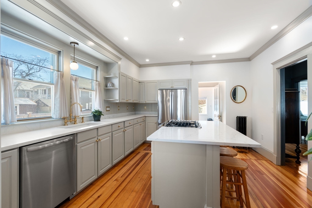 271 Atlantic Street Quincy, MA 02171 - Photo 7 of 24 a kitchen with stainless steel appliances granite countertop a sink stove and refrigerator