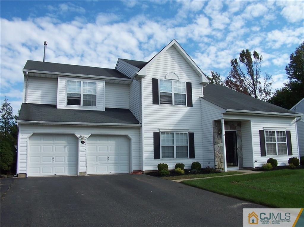 6 Nutmeg Road Aberdeen, NJ 07747 - Photo 1 of 24 a front view of a house with a yard and garage