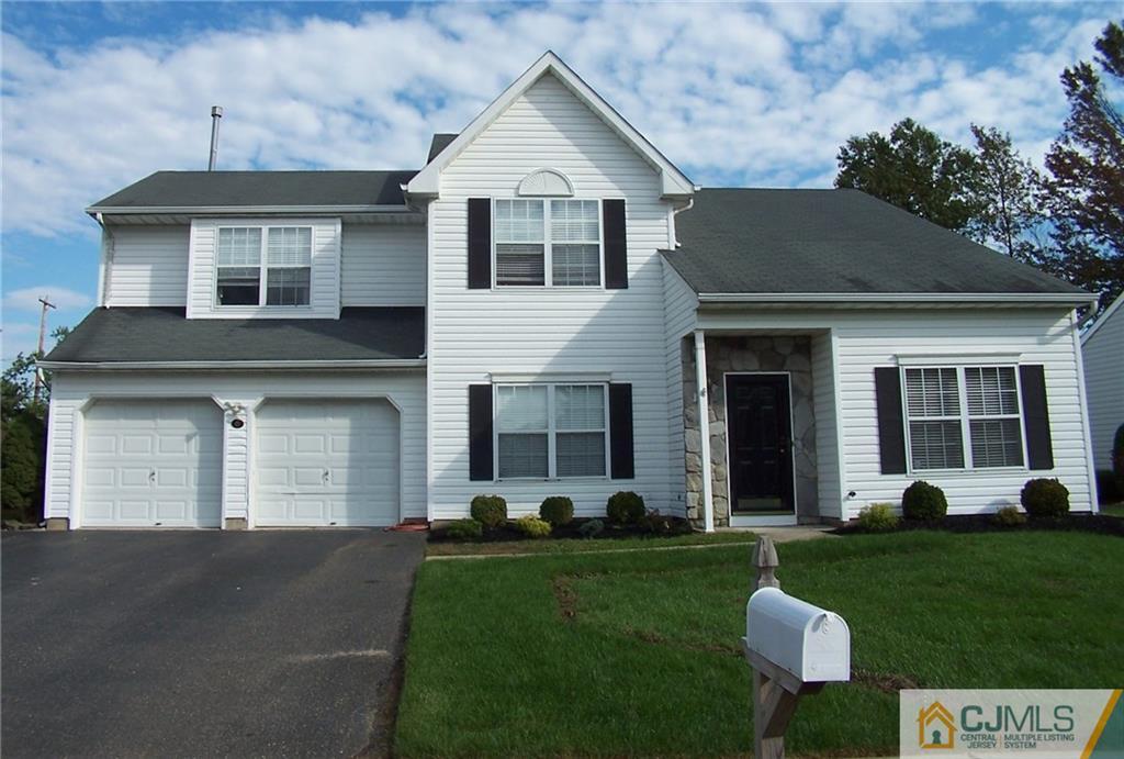 6 Nutmeg Road Aberdeen, NJ 07747 - Photo 2 of 24 a front view of a house with a yard fire pit