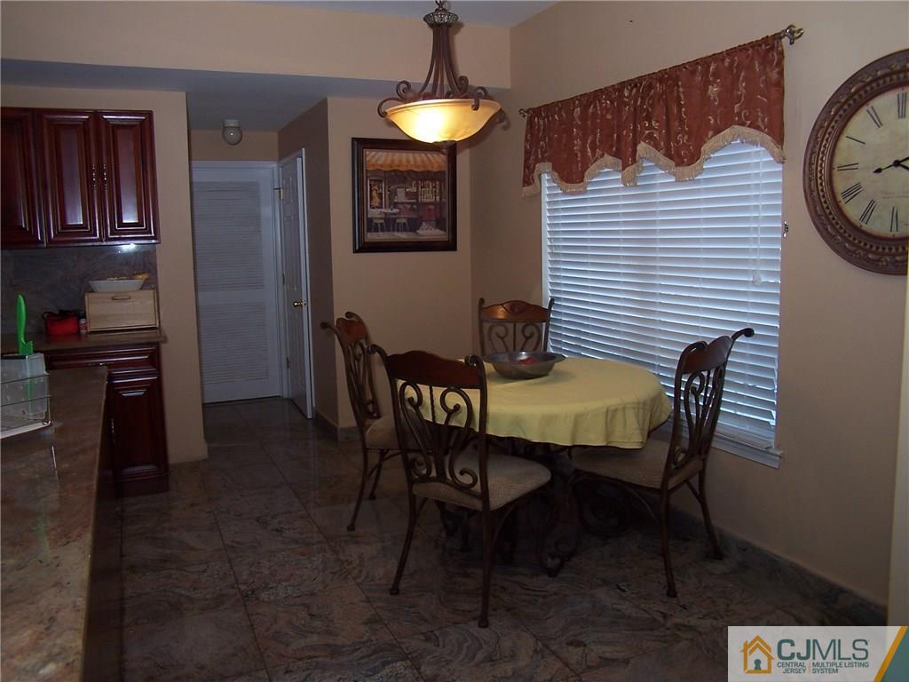6 Nutmeg Road Aberdeen, NJ 07747 - Photo 12 of 24 a dining room with furniture and window