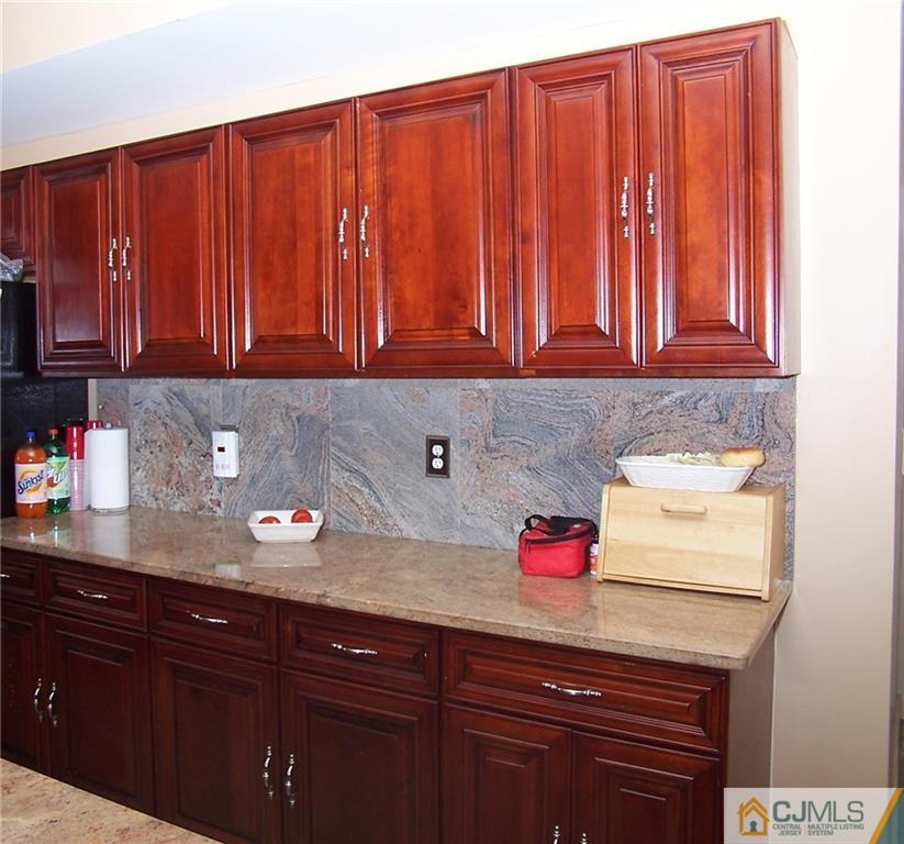 6 Nutmeg Road Aberdeen, NJ 07747 - Photo 13 of 24 a kitchen with wooden cabinets and a sink