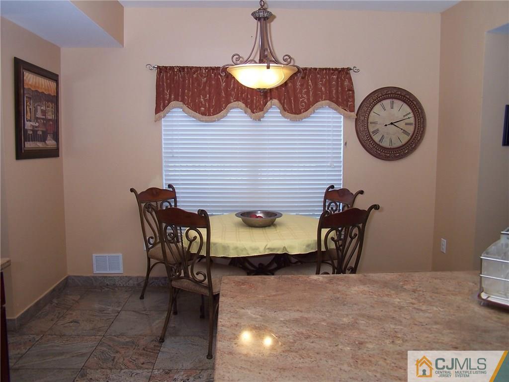 6 Nutmeg Road Aberdeen, NJ 07747 - Photo 15 of 24 a view of a dining room with furniture and a chandelier