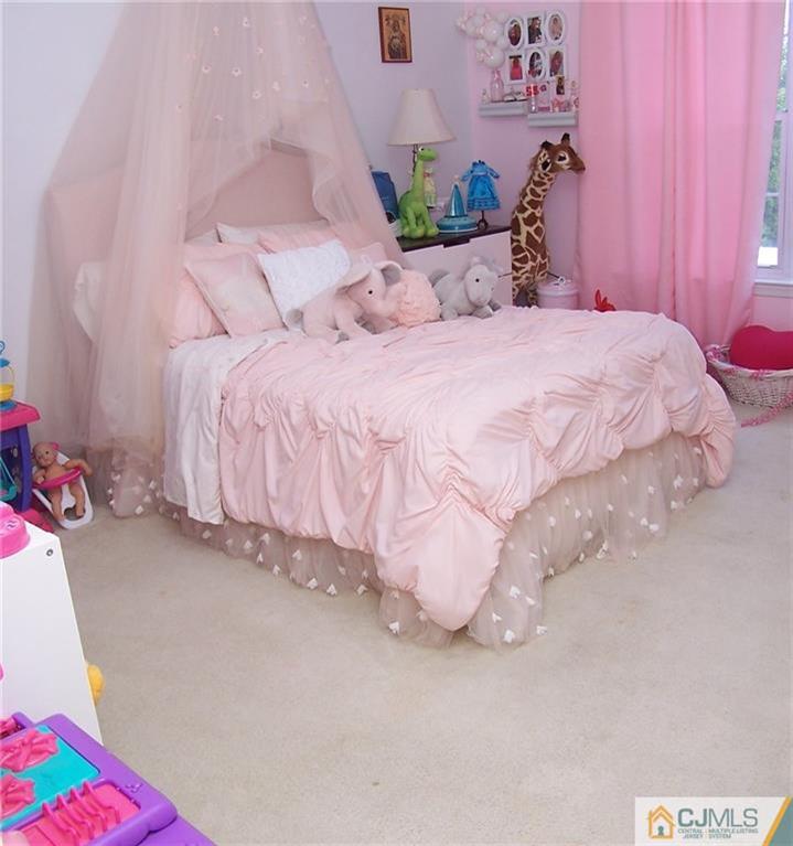 6 Nutmeg Road Aberdeen, NJ 07747 - Photo 18 of 24 a large bed sitting in a bedroom next to a window