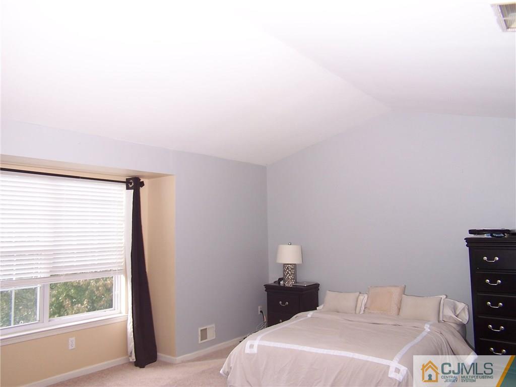 6 Nutmeg Road Aberdeen, NJ 07747 - Photo 19 of 24 a bedroom with a bed and a window