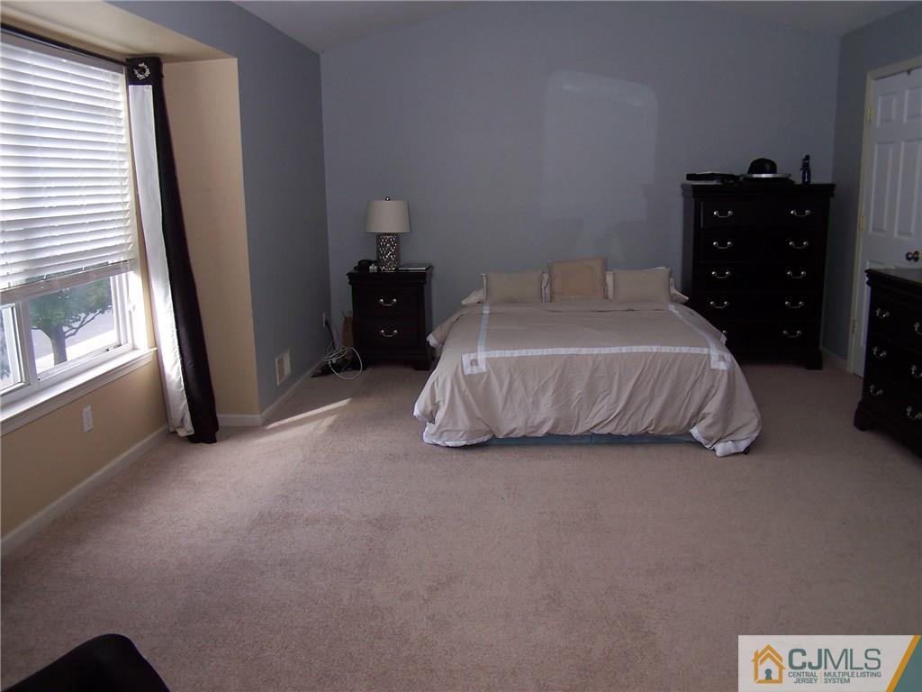 6 Nutmeg Road Aberdeen, NJ 07747 - Photo 20 of 24 a bedroom with a bed and a window