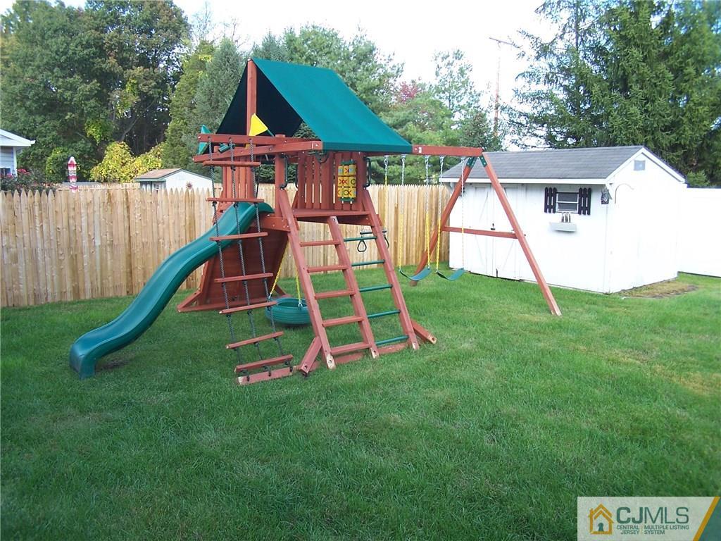 6 Nutmeg Road Aberdeen, NJ 07747 - Photo 23 of 24 a view of a house with backyard and a slide