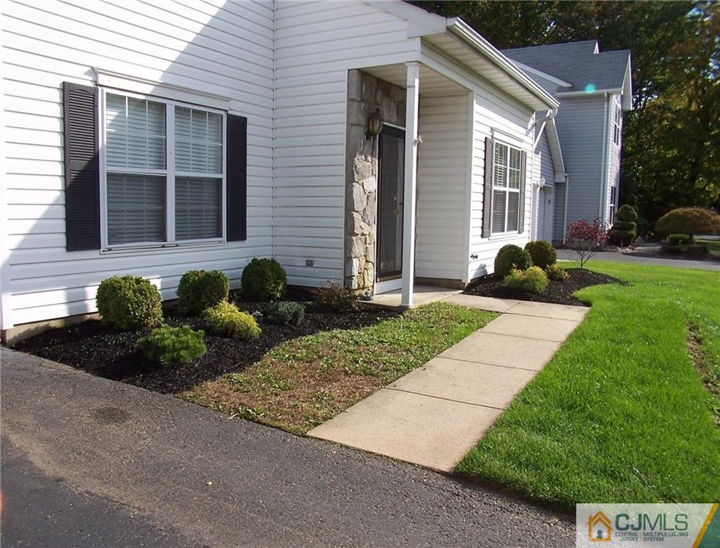 6 Nutmeg Road Aberdeen, NJ 07747 - Photo 4 of 24 a front view of a house with a yard