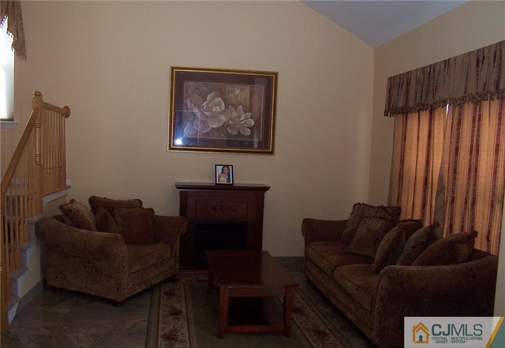 6 Nutmeg Road Aberdeen, NJ 07747 - Photo 9 of 24 a living room with furniture and a window