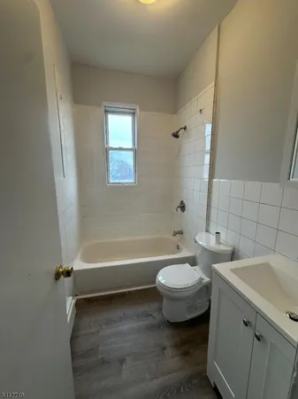 a bathroom with a toilet a sink and bathtub