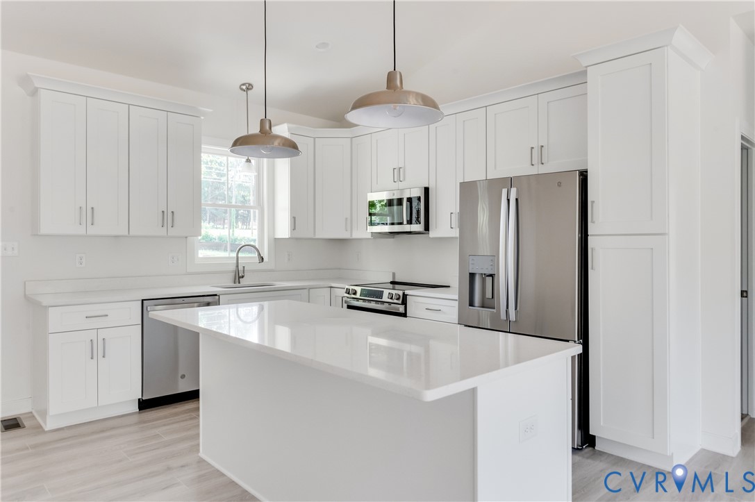 1393 Broad St Road Oilville, VA 23129 - Photo 10 of 39 Kitchen featuring a kitchen island, white cabinetr