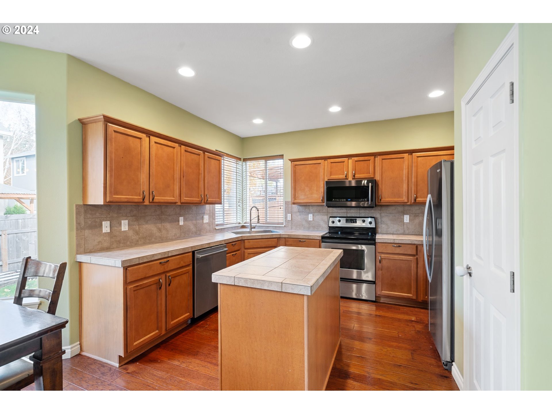 39833 Evans Street Sandy, OR 97055 - Photo 12 of 37 a kitchen with stainless steel appliances granite countertop a sink stove and refrigerator