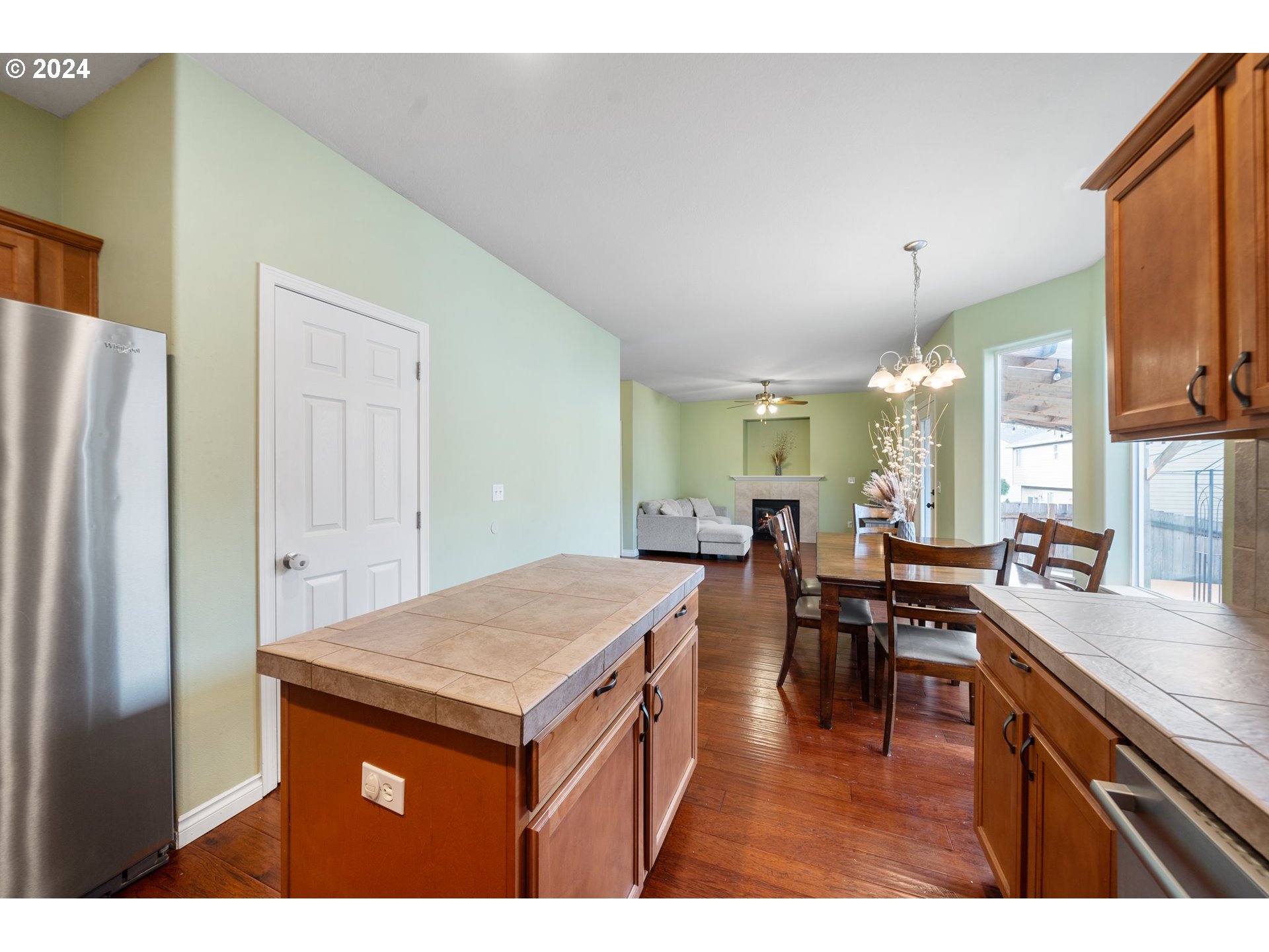 39833 Evans Street Sandy, OR 97055 - Photo 15 of 37 a kitchen with stainless steel appliances granite countertop a table chairs and a refrigerator