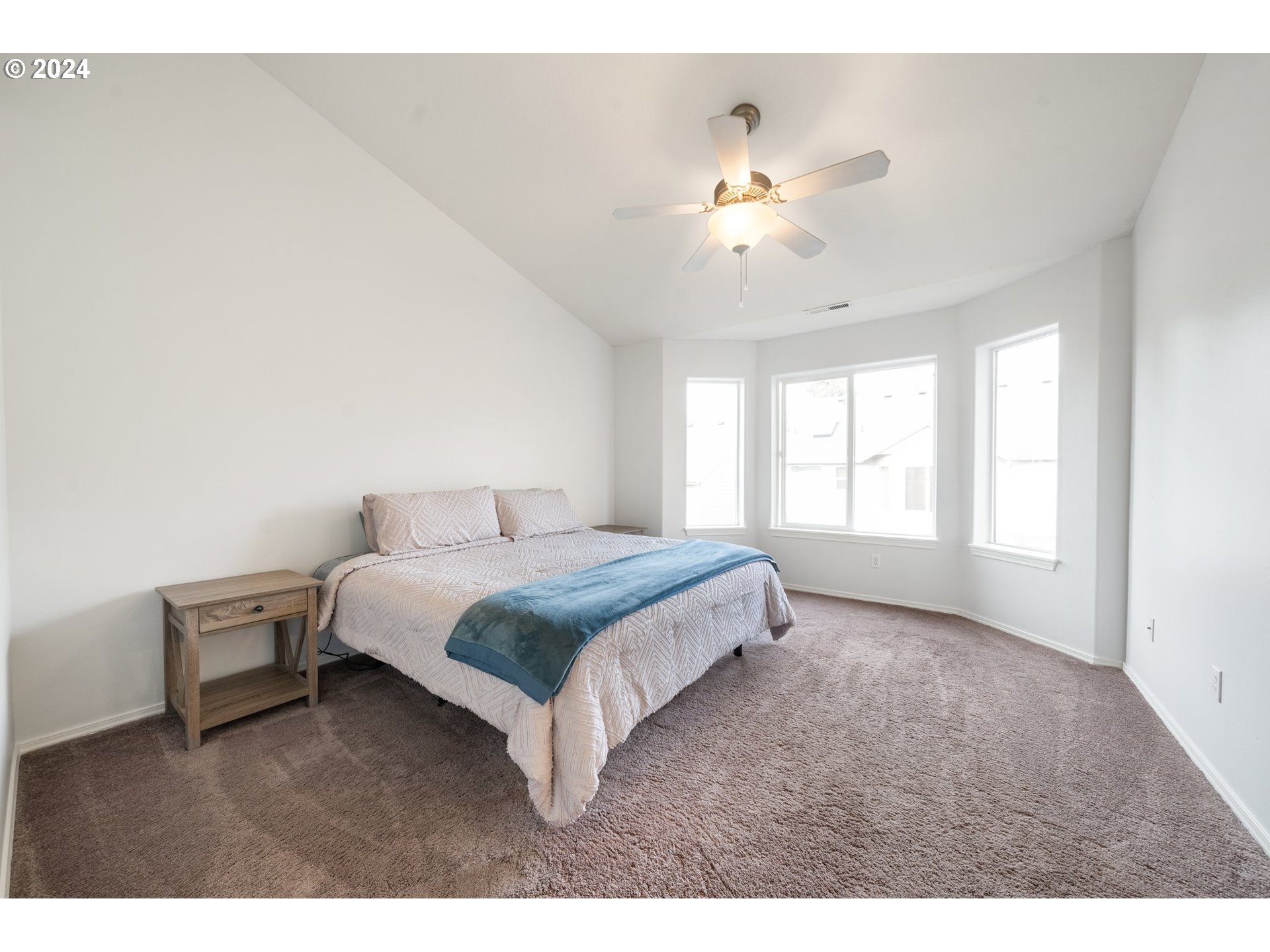 39833 Evans Street Sandy, OR 97055 - Photo 18 of 37 a spacious bedroom with a bed and a chandelier