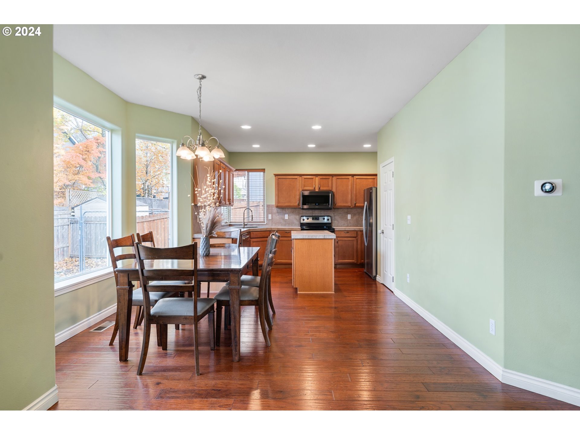 39833 Evans Street Sandy, OR 97055 - Photo 10 of 37 a dining room with furniture wooden floor and a floor to ceiling window