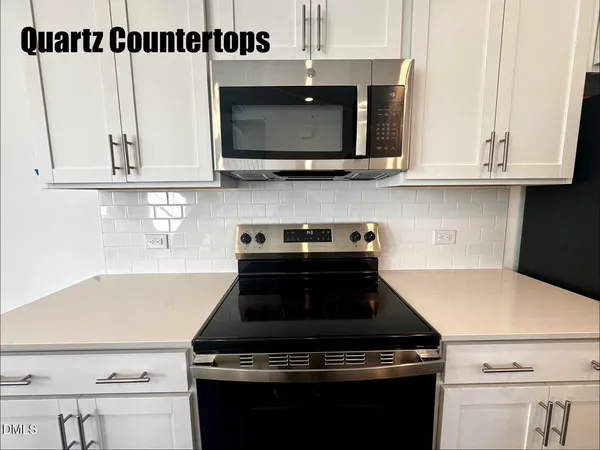 a kitchen with stainless steel appliances a stove and a microwave