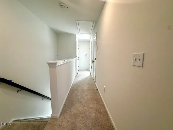 a view of a hallway with white walls
