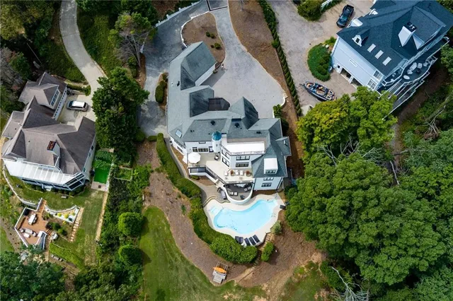 a kitchen with a stove a sink a center island and wooden cabinets