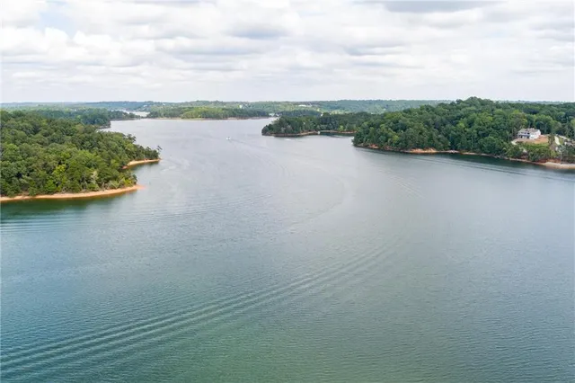 a kitchen with stainless steel appliances granite countertop a sink a stove a refrigerator and island with wooden floor