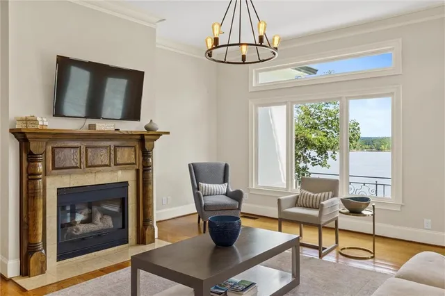 a living room with furniture flat screen tv and a large window